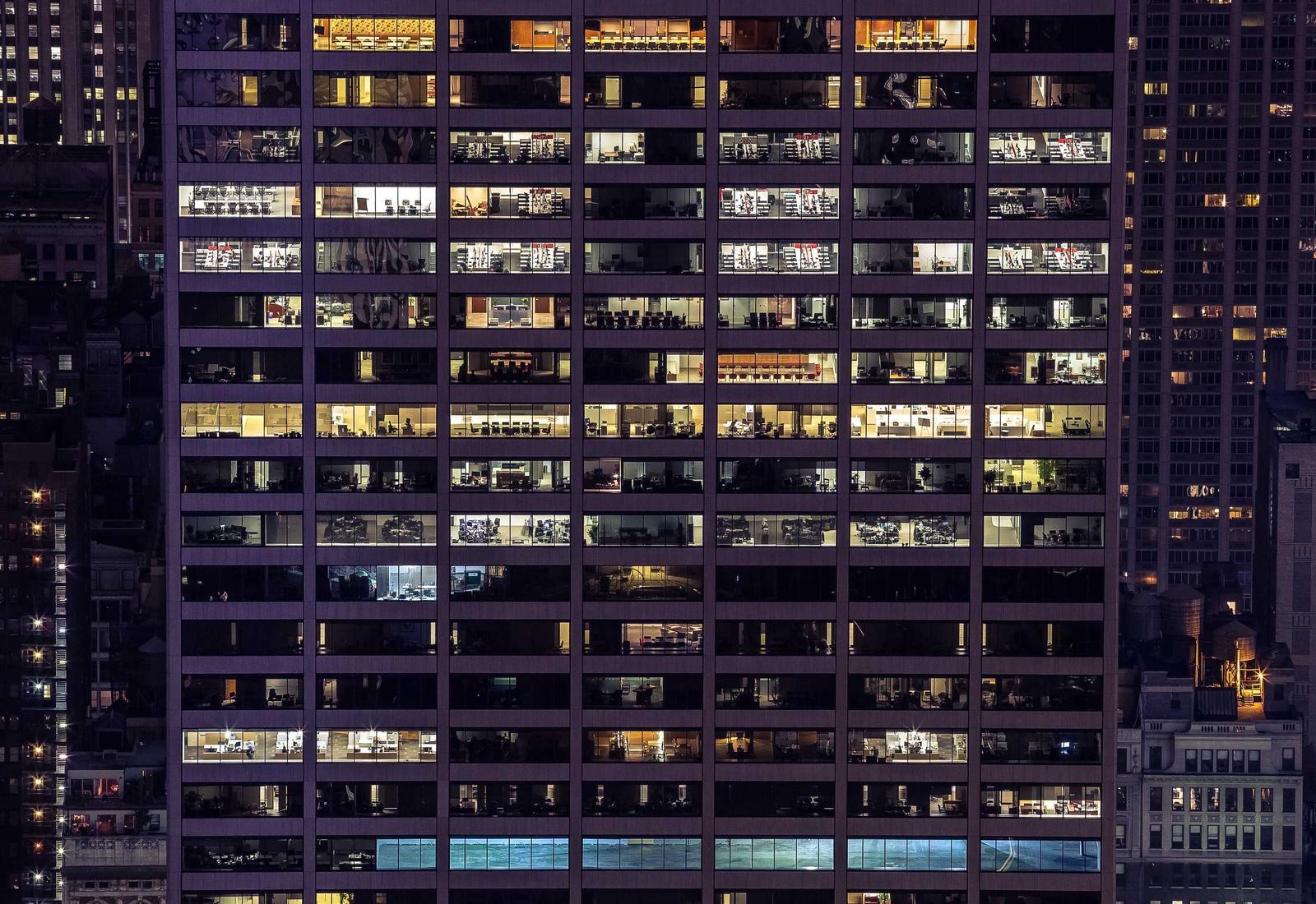 An office building with its windows lit at night