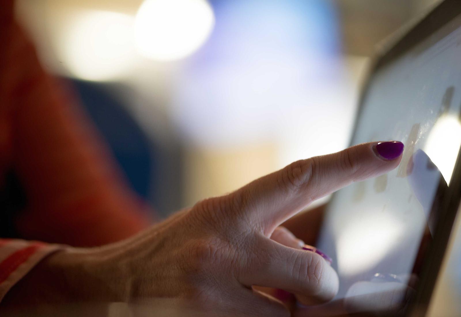 A hand using a tablet